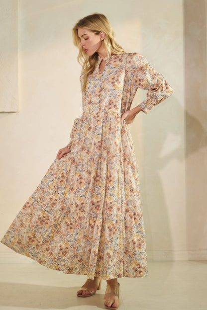 Long sleeve floral maxi dress by Lovelo featuring a flowing design and vibrant flower pattern, perfect for elegant daytime wear.