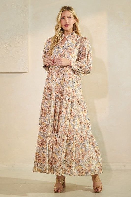 Long sleeve floral maxi dress from Lovelo featuring a flowing design and vibrant floral pattern.