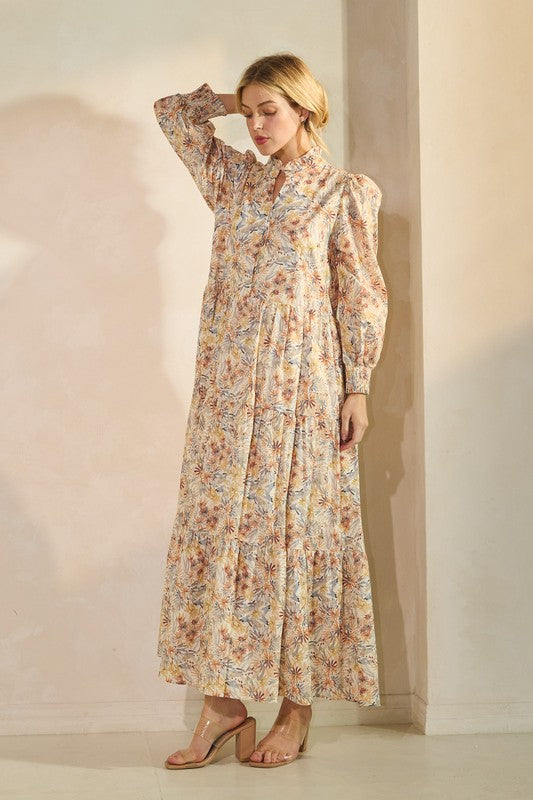 Long sleeve floral maxi dress from Lovelo featuring a flowing silhouette and vibrant floral pattern.