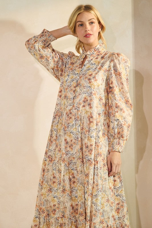Long sleeve floral maxi dress from Lovelo with a flowing silhouette and vibrant floral pattern, perfect for elegant daytime wear.