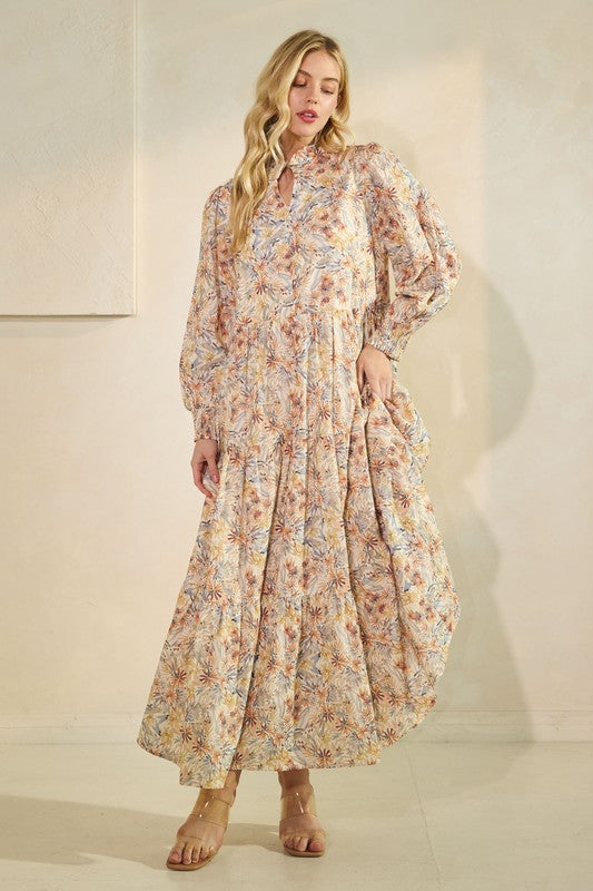 Long sleeve floral maxi dress from Lovelo featuring a flowing silhouette and vibrant flower print, perfect for elegant summer wear.
