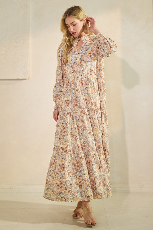 Long sleeve floral maxi dress by Lovelo featuring a flowing silhouette and vibrant floral print.
