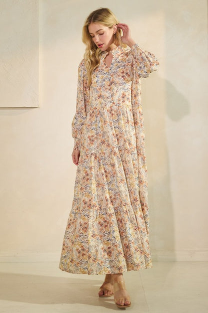 Long sleeve floral maxi dress by Lovelo featuring a flowing silhouette and vibrant flower print for elegant summer wear.
