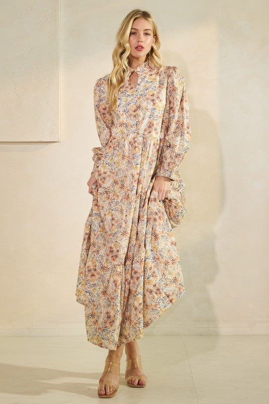 Long sleeve floral maxi dress from Lovelo featuring a flowing silhouette and vibrant flower print.