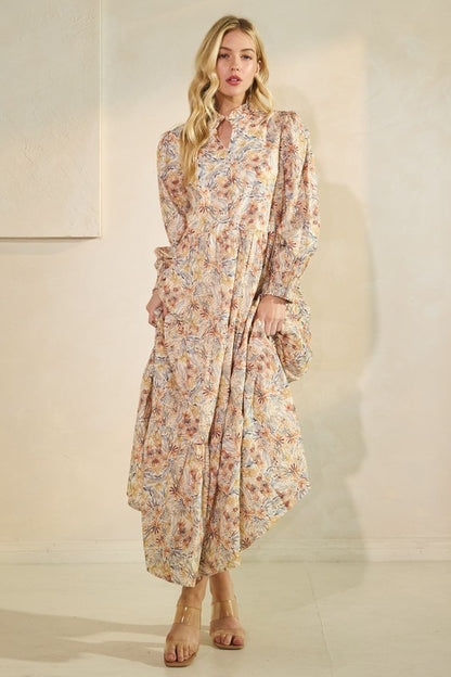 Long sleeve floral maxi dress by Lovelo featuring a vibrant floral pattern and flowy silhouette.