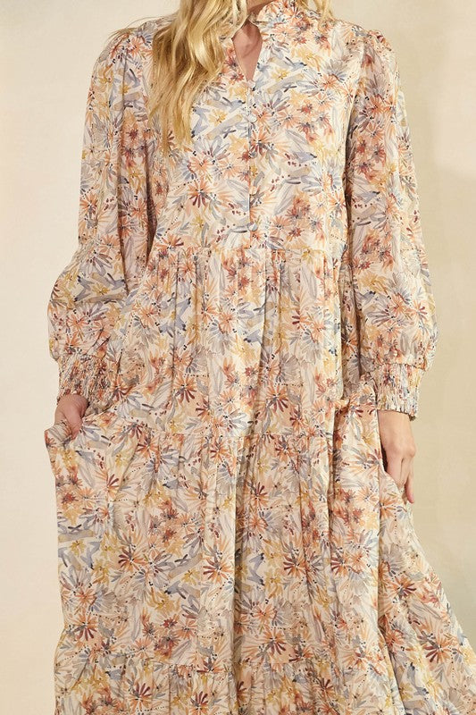 Long sleeve floral maxi dress by Lovelo featuring vibrant floral patterns and a flowing silhouette.