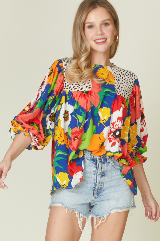 Floral mixed print blouse with round neck from Modest and Devoted Designs, featuring a stylish blouse top with vibrant floral patterns.