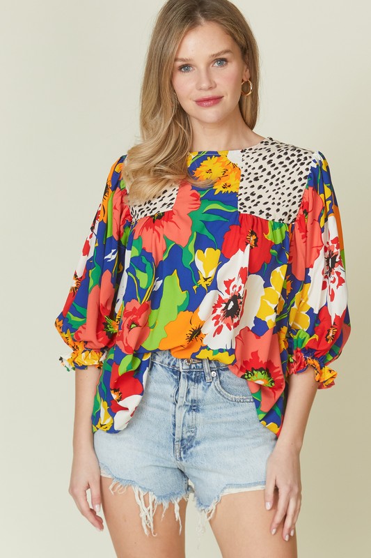 Floral mixed print blouse with round neck from Modest and Devoted Designs, casual top featuring colorful floral patterns.