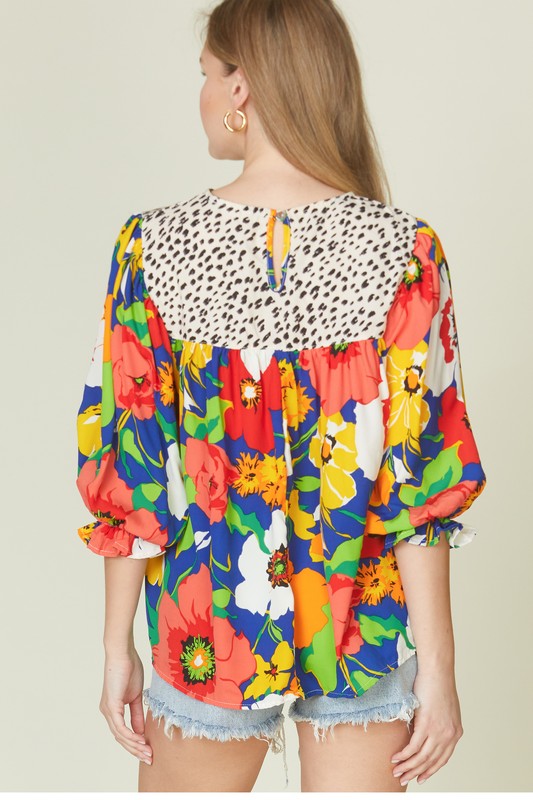 Floral mixed print blouse with round neck from Modest and Devoted Designs, casual top featuring vibrant floral pattern.