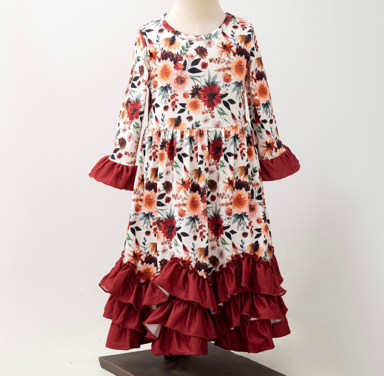 Girls Maxi Mahogany Bouquet Long Sleeve Ruffle Dress by ModestAndDevoted, featuring a floral pattern and ruffled sleeves.