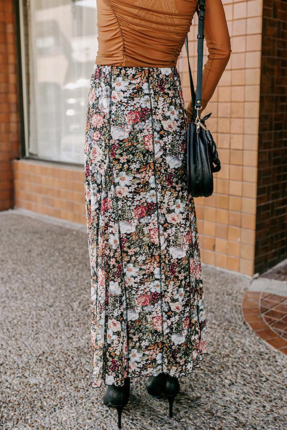 Brown floral print high waist maxi skirt from ModestAndDevoted, made of polyester and elastane, flowing skirt with vibrant floral pattern.