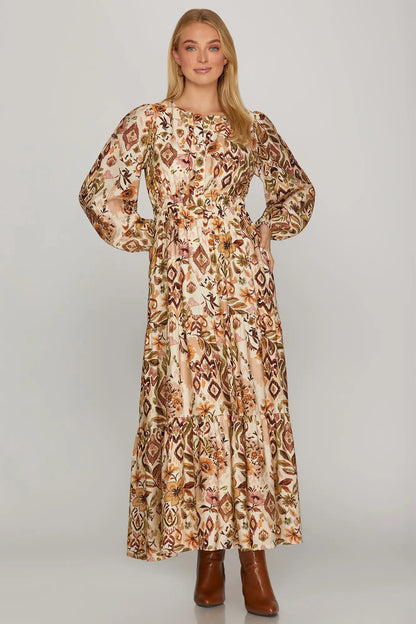 Brown and olive boho fall floral long sleeve maxi dress by ModestAndDevoted, featuring abstract floral pattern and flowing silhouette.