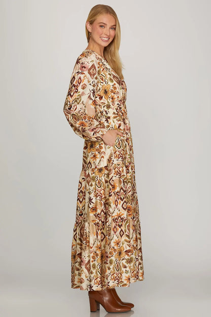 ModestAndDevoted boho fall floral maxi dress with long sleeves in brown and olive, featuring an abstract floral pattern.