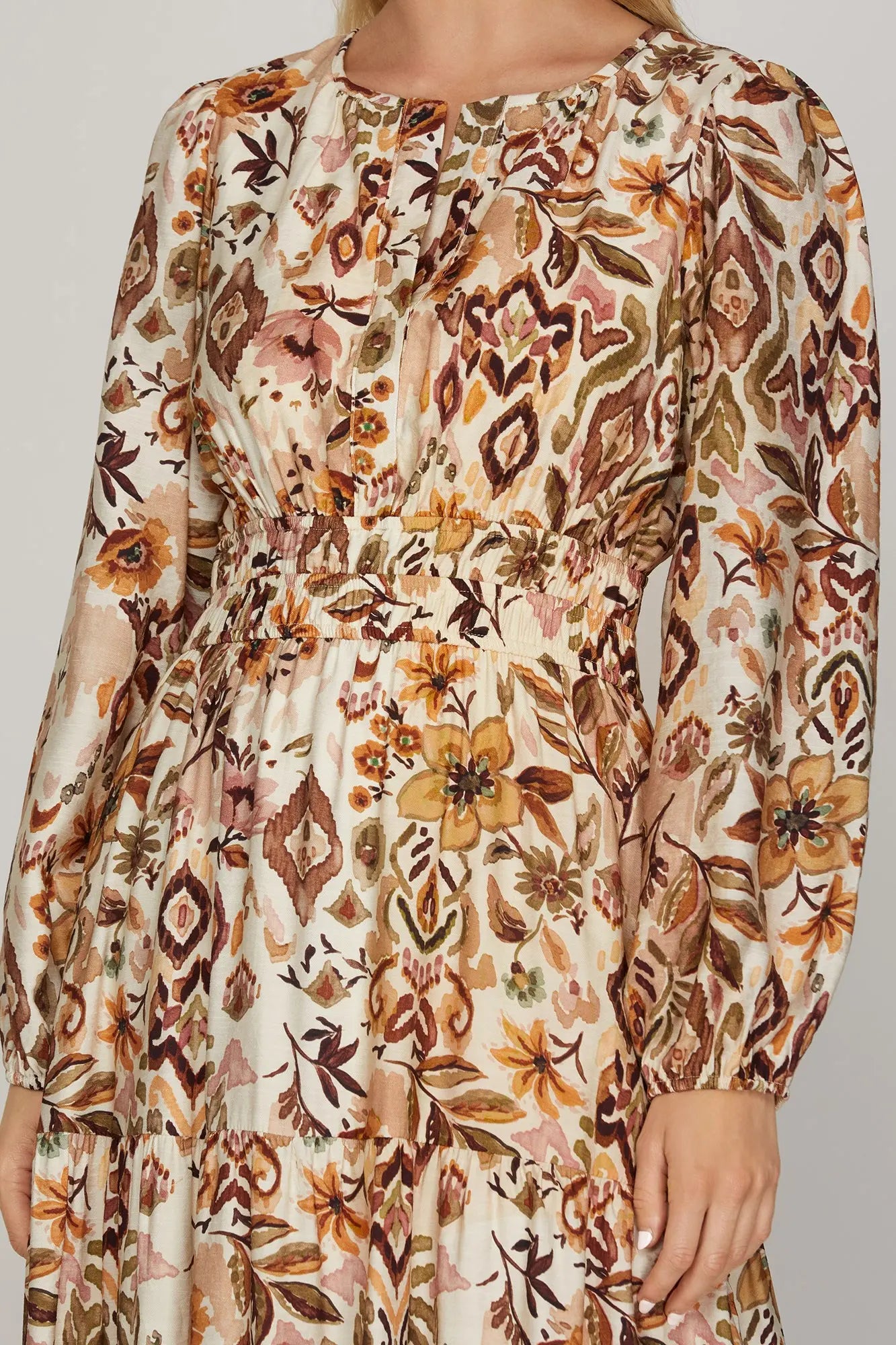 ModestAndDevoted boho fall floral maxi dress with long sleeves in brown and olive, featuring an abstract floral pattern.