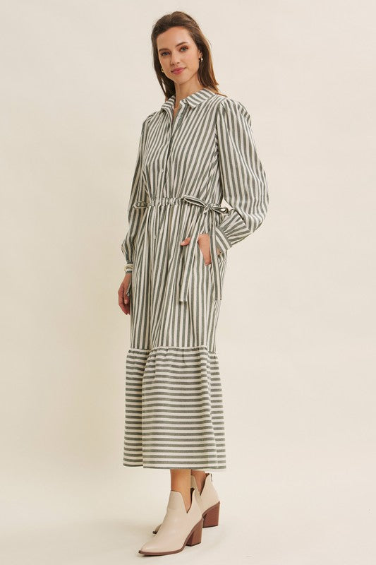 Deep green cotton stripe maxi dress with buttons and belt by ModestAndDevoted, featuring a classic button-down design and flowing silhouette.