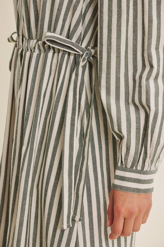 Deep green cotton stripe maxi dress with buttons and belt from ModestAndDevoted, featuring a classic button-down design and flowy silhouette.