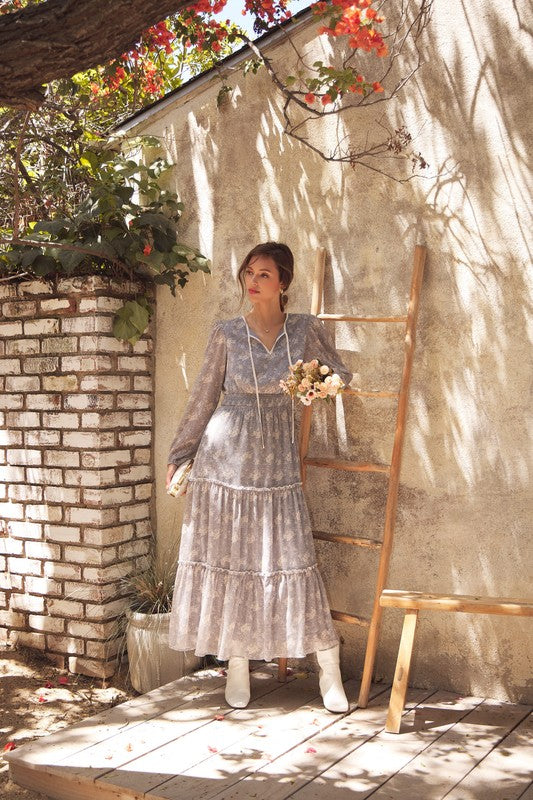 Dusty blue Romantic Flora maxi dress by ModestAndDevoted with a smocked waist, flowing fabric, and floral pattern.
