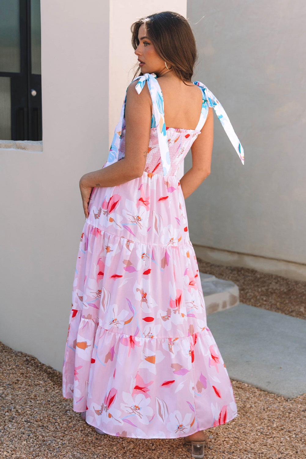 Pink floral print maxi dress by ModestAndDevoted with knotted shoulders and smocked bodice, made from lightweight polyester fabric.