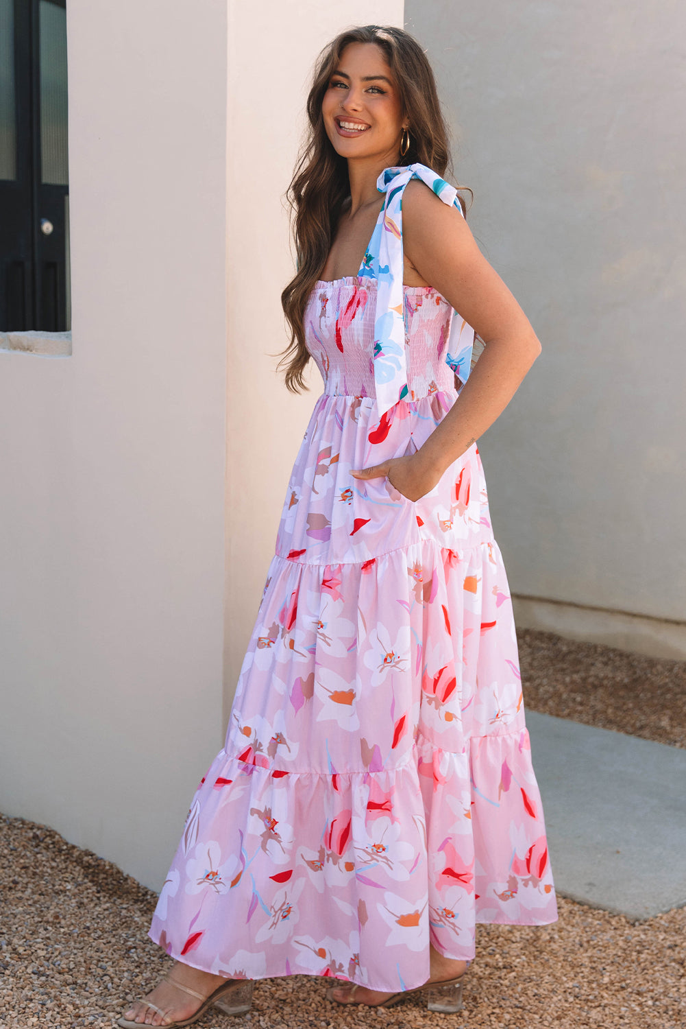 Pink floral print maxi dress with knotted shoulders and smocked bodice by ModestAndDevoted, featuring a flowing design and polyester fabric.
