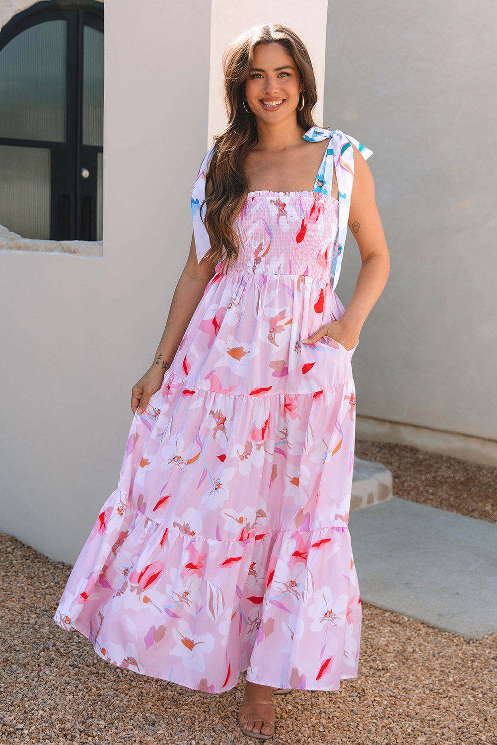 Pink floral print knotted shoulder smocked maxi dress by ModestAndDevoted, featuring a flowy design and feminine floral pattern.