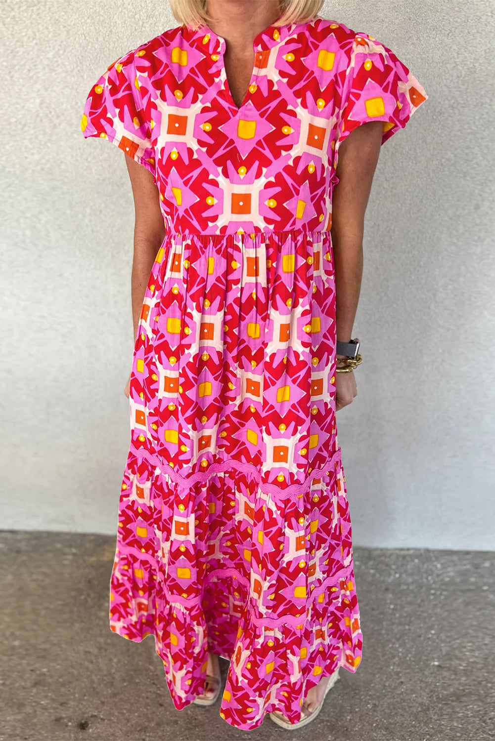 Strawberry Pink Geo Print V-neck Maxi Dress by ModestAndDevoted, featuring a flowing polyester fabric and vibrant geometric pattern.