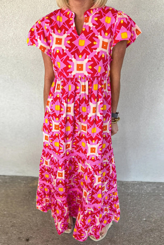 Strawberry Pink Geo Print V-neck Maxi Dress by ModestAndDevoted, featuring a flowing polyester fabric and vibrant geometric pattern.