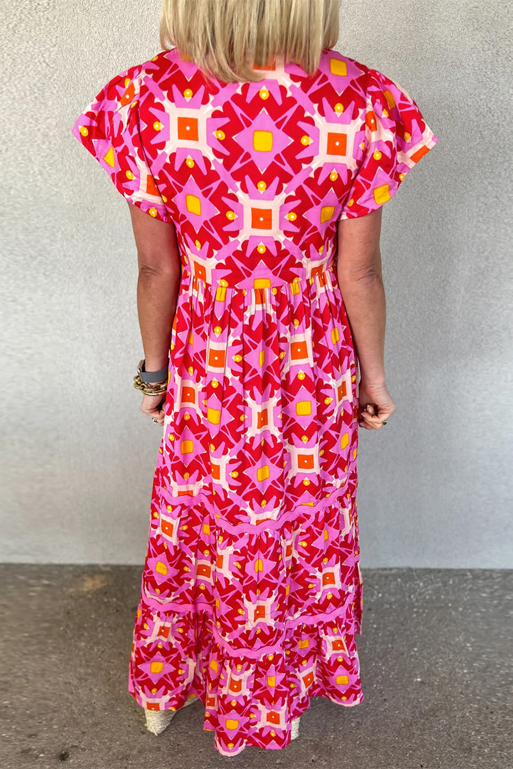 Strawberry pink geo print maxi dress with V-neck and short sleeves, made of polyester, from ModestAndDevoted.