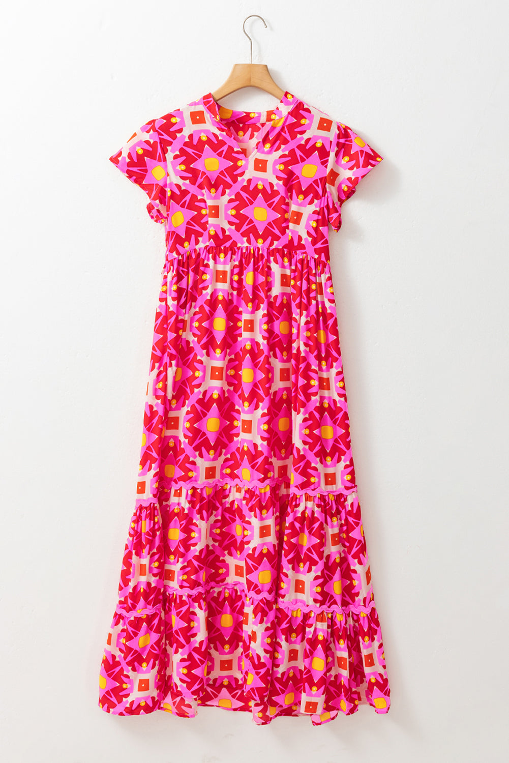 Strawberry pink geo print V-neck maxi dress by ModestAndDevoted, featuring a flowing polyester fabric and elegant design.