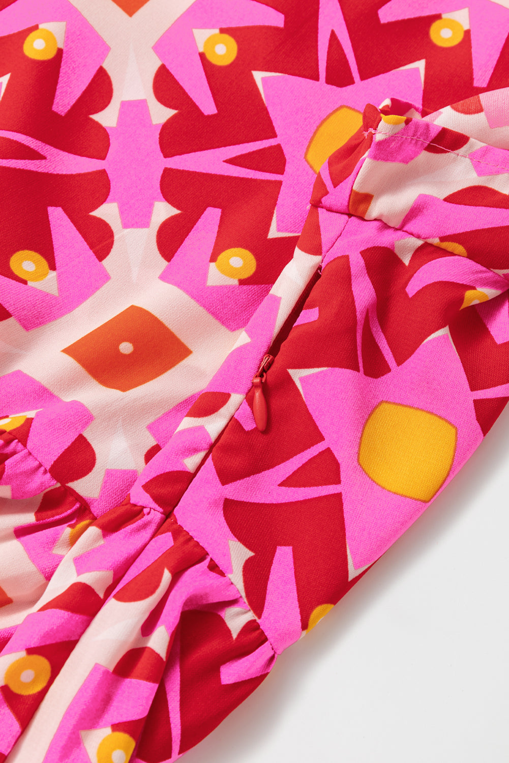 Strawberry pink geo print V-neck maxi dress by ModestAndDevoted, featuring a flowing polyester fabric and elegant design.
