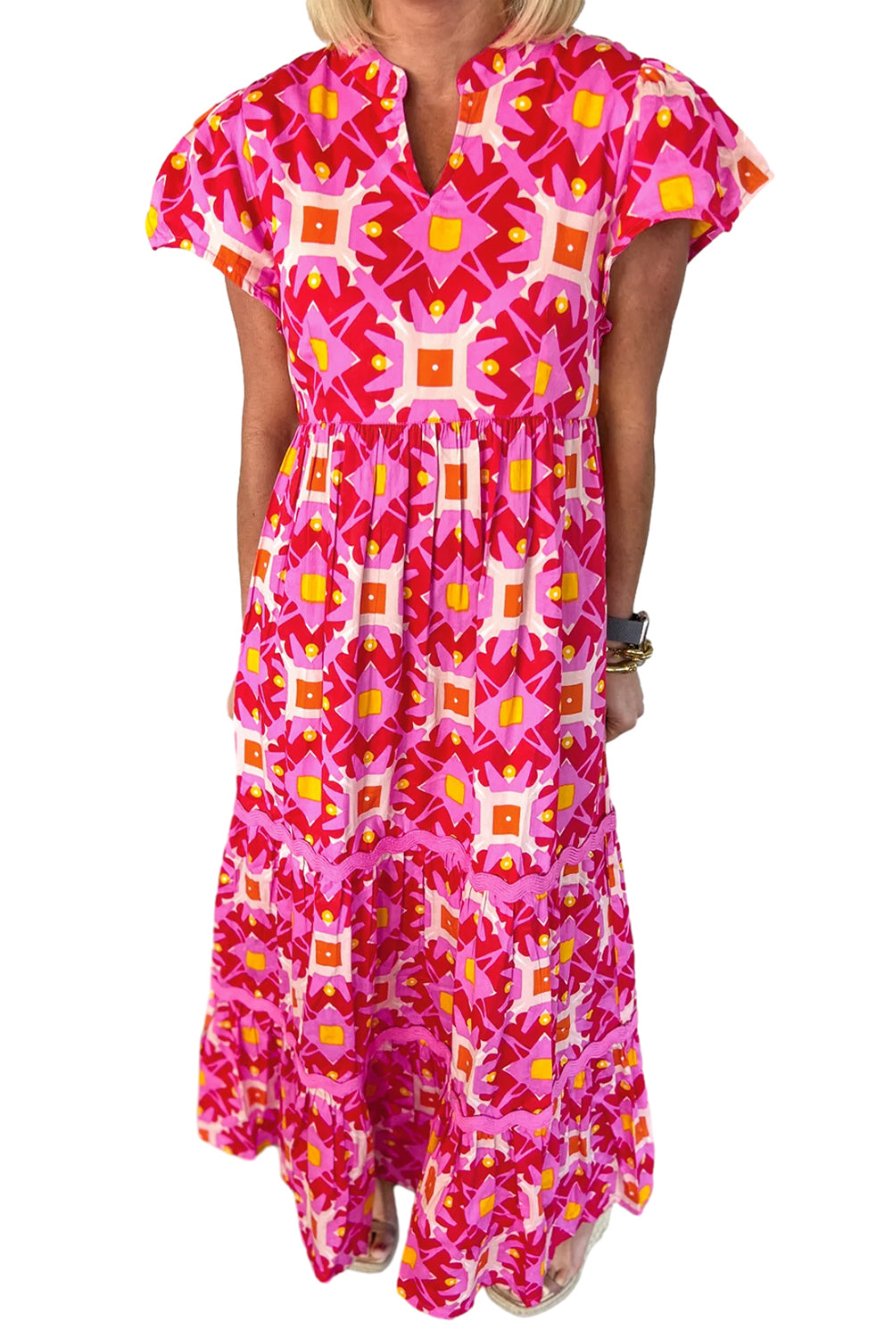 Strawberry pink Geo print V-neck maxi dress by ModestAndDevoted, featuring a flowy polyester fabric and elegant design.