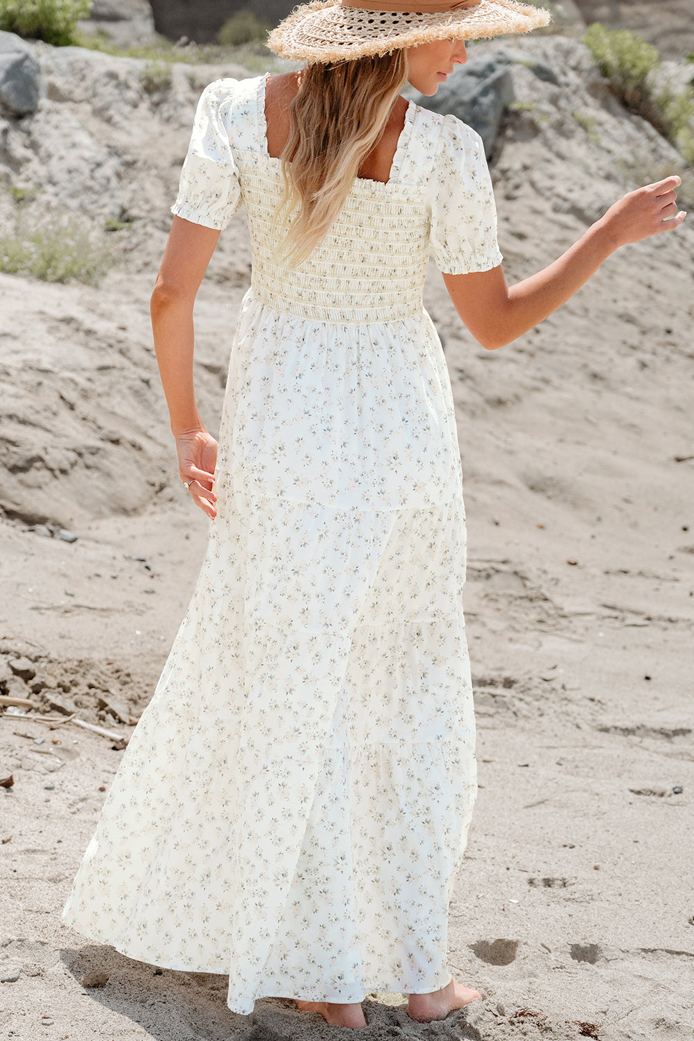 White floral maxi dress with frilly bodice and tiered design from ModestAndDevoted, featuring shirred details and lightweight polyester fabric.