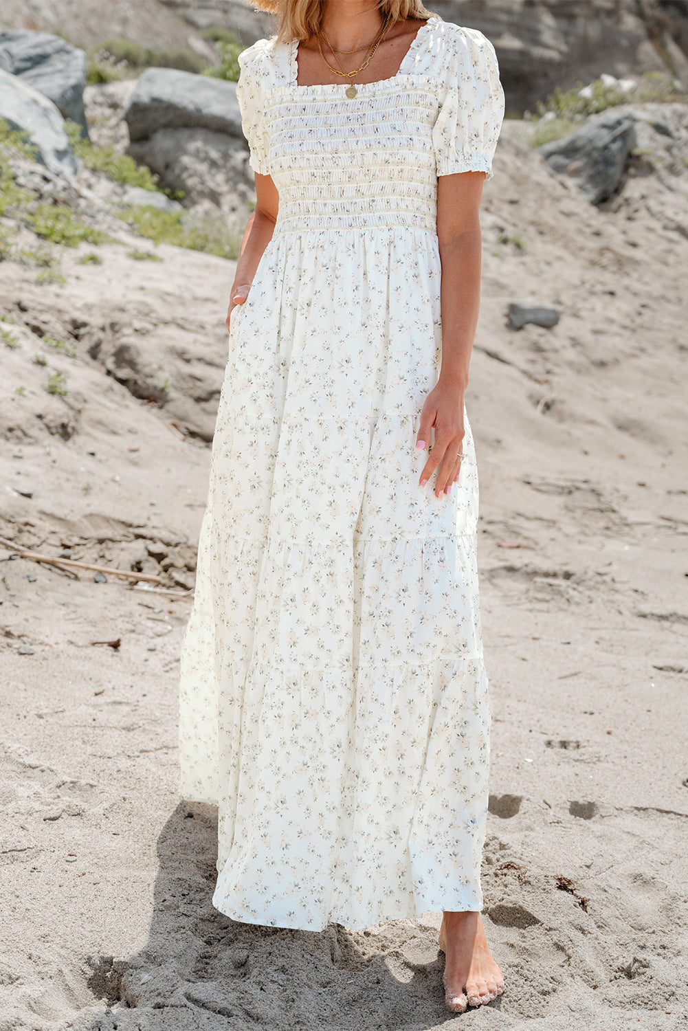 White floral maxi dress by ModestAndDevoted featuring a frilly shirred bodice and tiered design, perfect for summer wear.