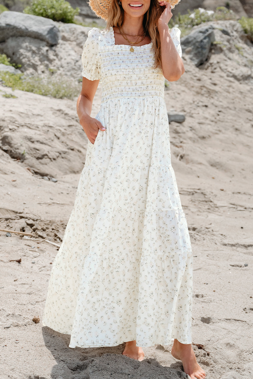 White floral maxi dress by ModestAndDevoted featuring a frilly shirred bodice and tiered design, perfect for elegant summer wear.