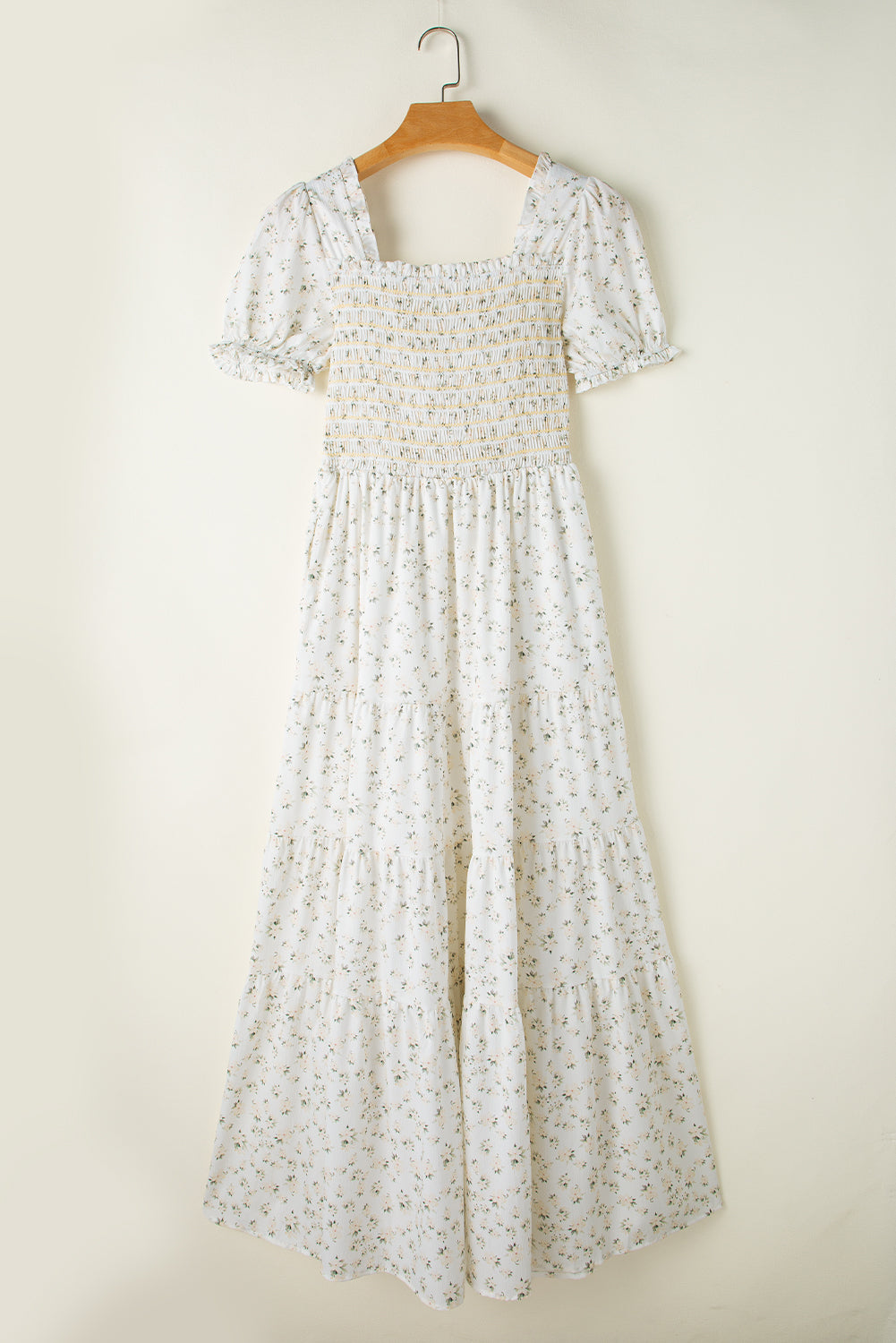 White floral maxi dress with frilly shirred bodice and tiered layers, featuring a flowy, elegant design from ModestAndDevoted.