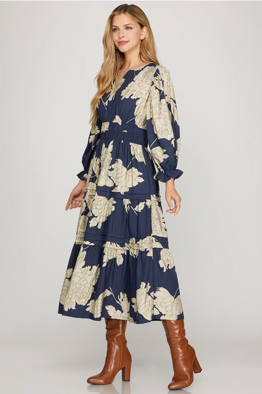 Navy pintuck tiered floral print maxi dress by ModestAndDevoted, featuring flowy layers and a feminine floral pattern.