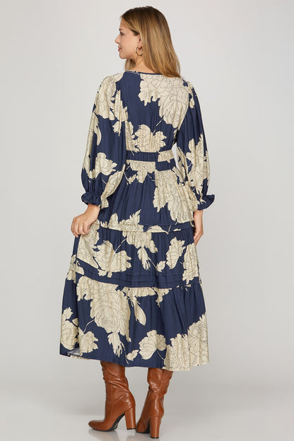 Navy Pintuck Tiered Floral Print Maxi Dress by ModestAndDevoted, featuring a flowing silhouette and intricate floral pattern.