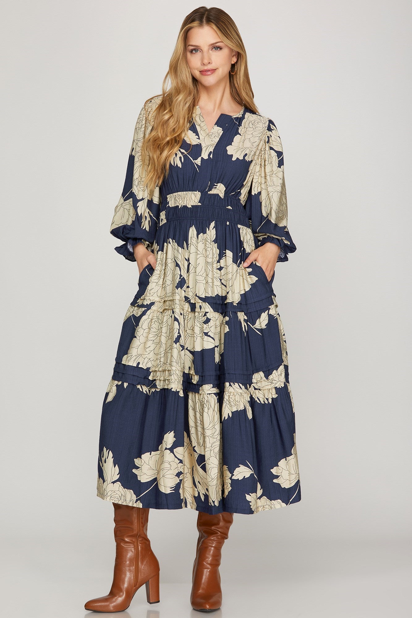 Navy Pintuck Tiered Floral Print Maxi Dress by ModestAndDevoted, featuring a flowing silhouette and detailed floral pattern.