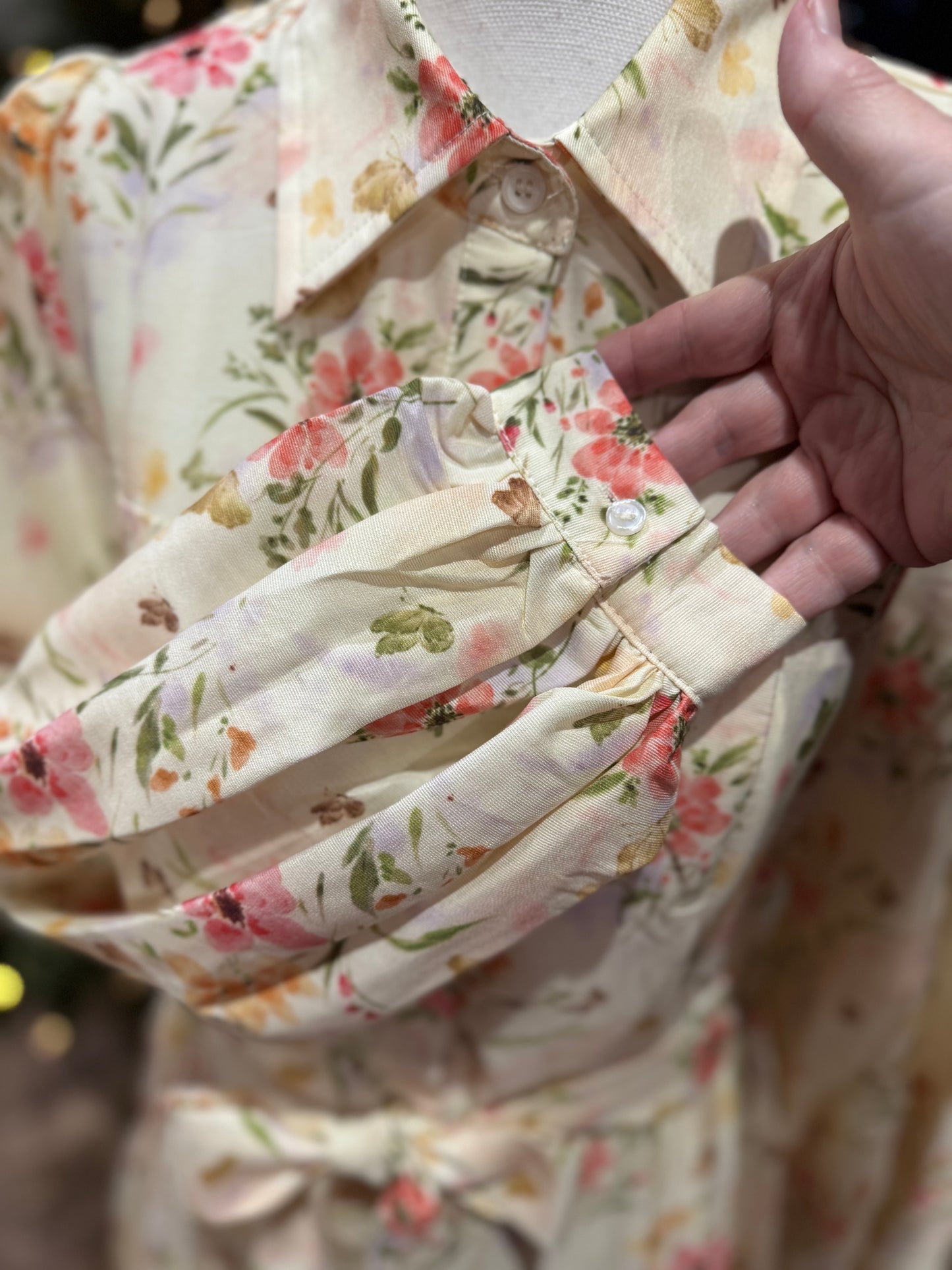 ModestAndDevoted Enchanted Garden floral button-down maxi dress with vibrant garden print, long sleeves, and flowing silhouette.