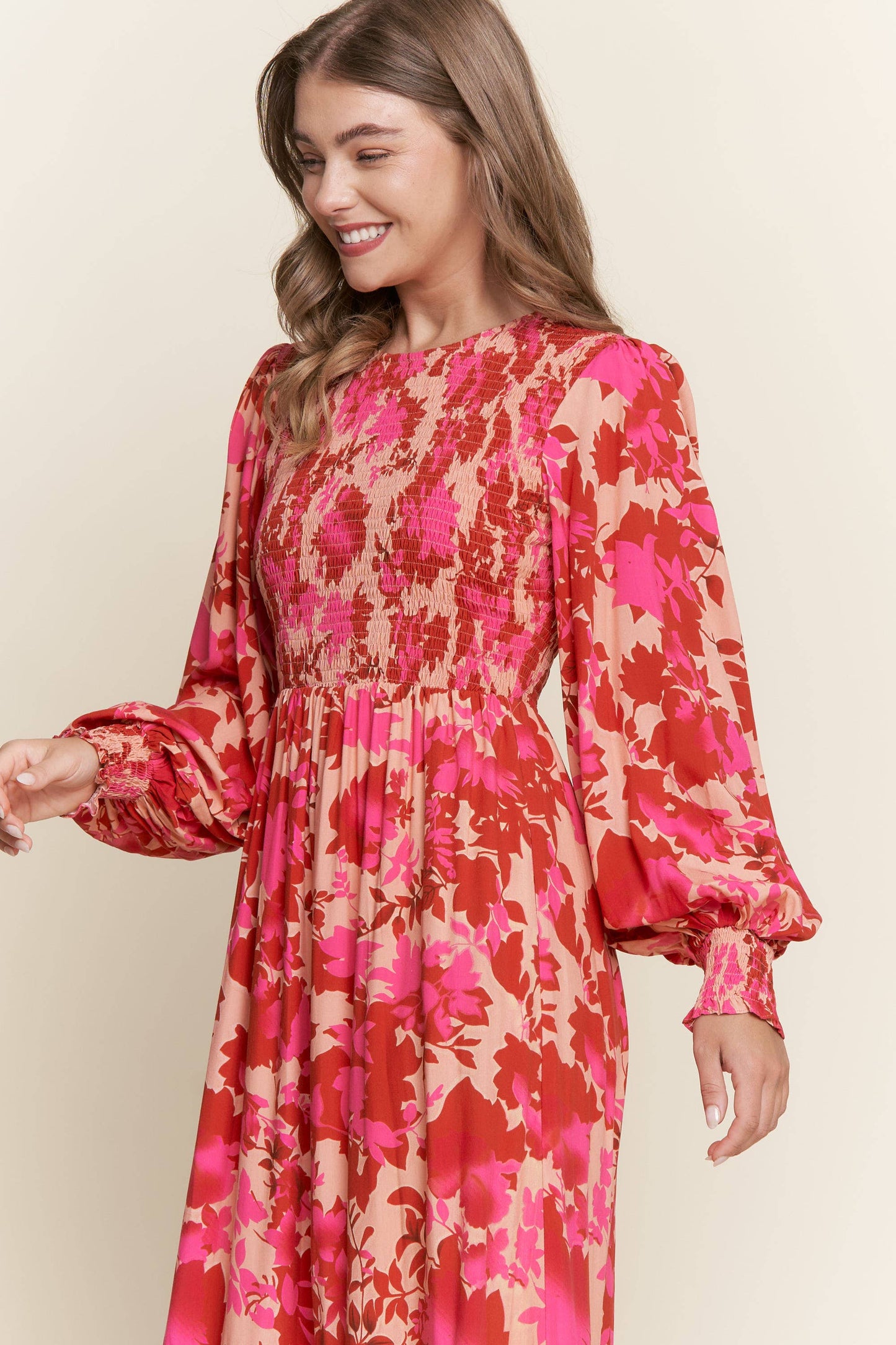 Long sleeve floral dress with smocked bodice by ModestAndDevoted, featuring bright, colorful floral patterns and a comfortable fit.