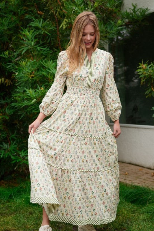 ModestAndDevoted novelty print maxi dress with pockets and detailed trim, flowing fabric, and vibrant design for a stylish look.