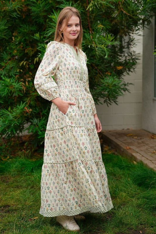 ModestAndDevoted novelty print maxi dress with pockets and detailed trim, flowing fabric, and vibrant design for elegant casual wear.