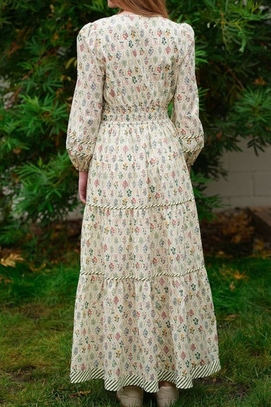 ModestAndDevoted novelty print maxi dress with pockets and detailed trim, flowing fabric and vibrant pattern.
