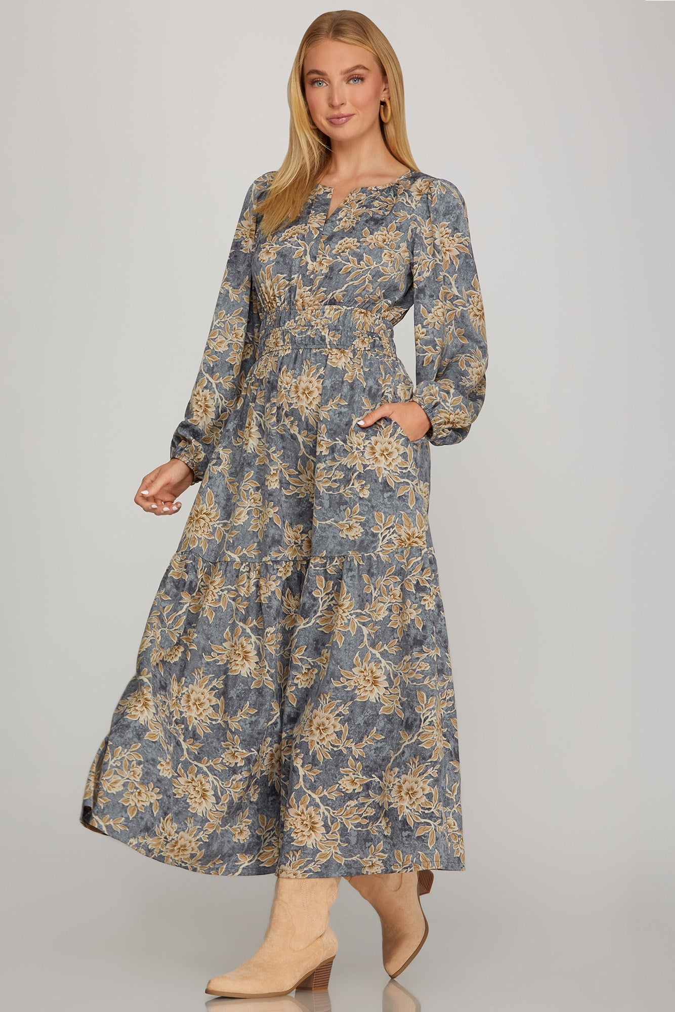 Long sleeve woven scroll print tiered maxi dress in dusty blue by ModestAndDevoted, featuring a flowing, layered design.