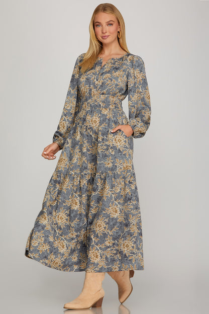Long sleeve woven scroll print tiered maxi dress in dusty blue by ModestAndDevoted, featuring a flowing, elegant design.