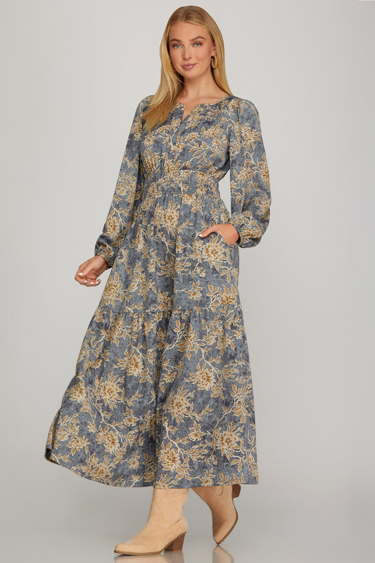 Long sleeve woven scroll print tiered maxi dress in dusty blue by ModestAndDevoted, featuring a flowing, layered design.