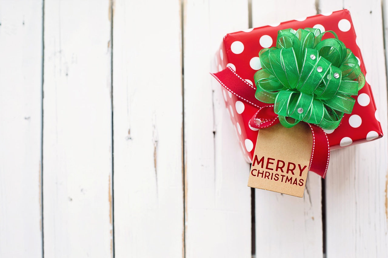 ModestAndDevoted Christmas gift card with festive garland and "Merry Christmas" message on a colorful background.