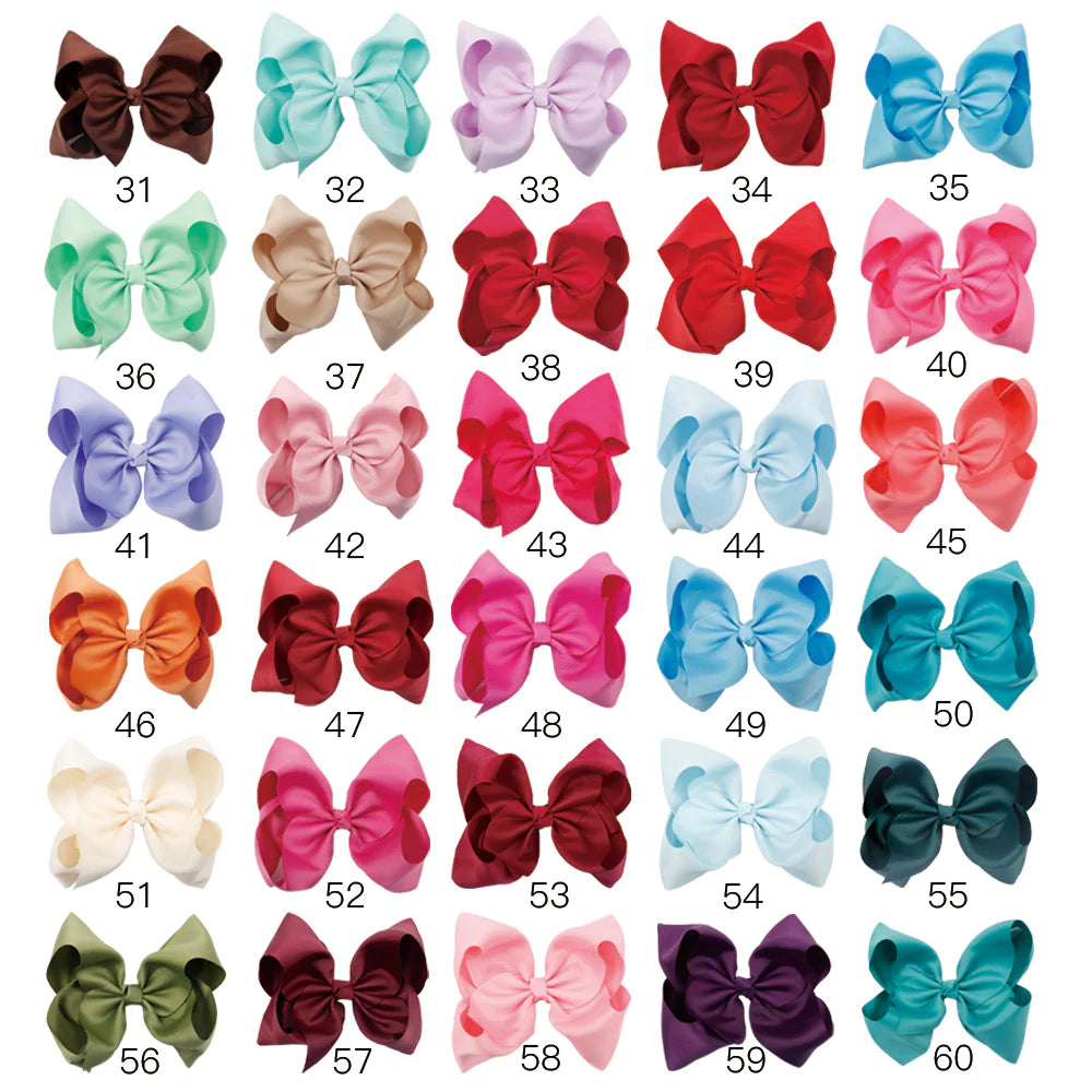 Large 8-inch boutique jumbo hairbow by ModestAndDevoted, made of soft fabric with a stylish, full bow design.