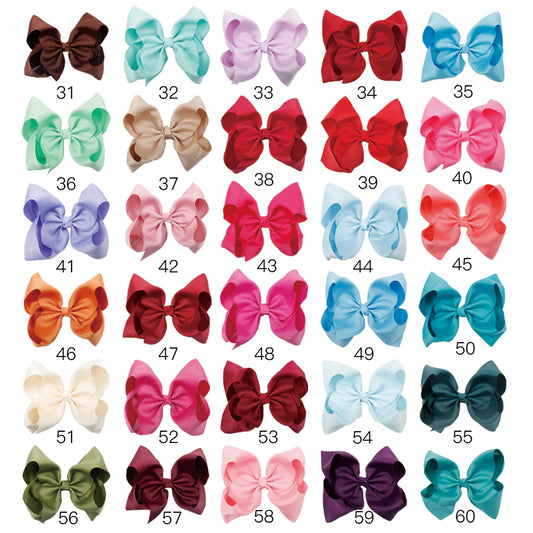 Large 8-inch boutique jumbo hairbow by ModestAndDevoted, made of soft fabric with a stylish, full bow design.