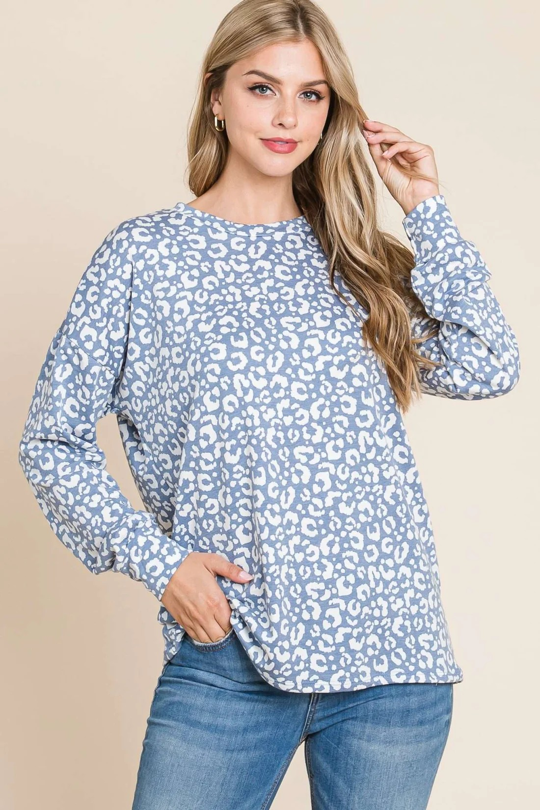 Blue long sleeve animal print top by ModestAndDevoted, featuring a stylish, fitted design with a subtle animal pattern.