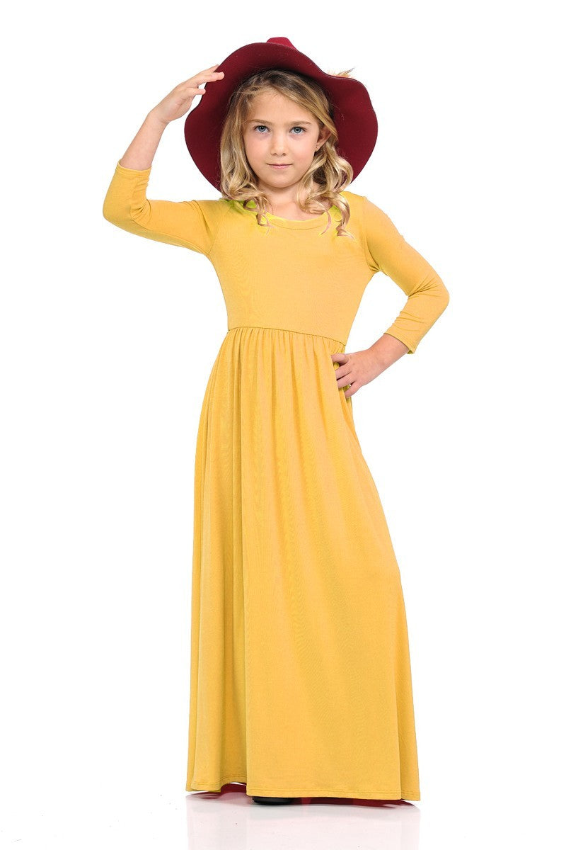 Girls solid peach maxi dress by ModestAndDevoted, featuring a comfortable, flowing design perfect for casual or special occasions.